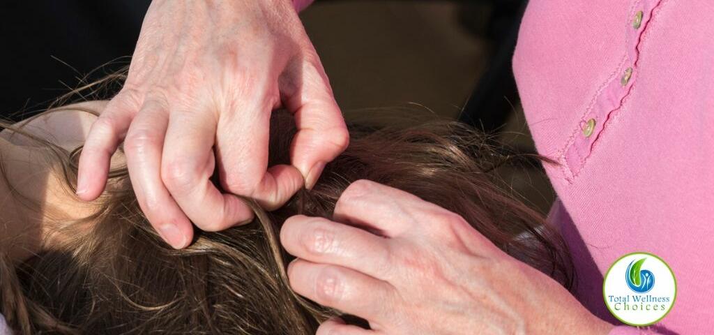 A woman looking for lice in her child's head
