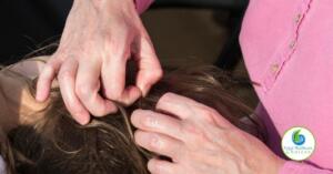 A woman looking for lice in her child's head