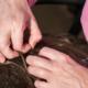 A woman looking for lice in her child's head