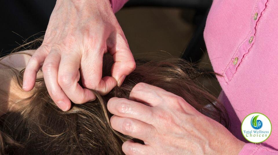 A woman looking for lice in her child's head