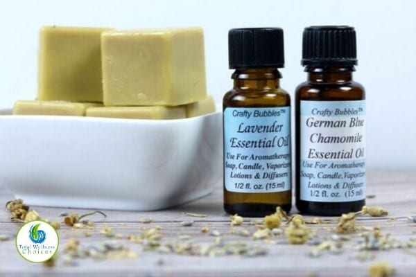 Solid lotion bars in a bowl and essential oil bottles