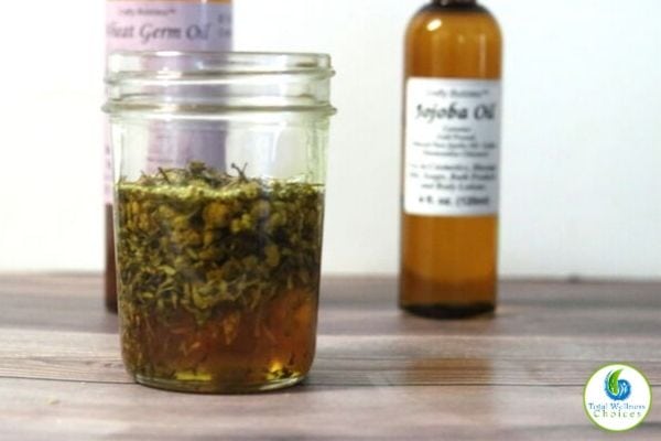 dry lavender and chamomile herbs in carrier oils